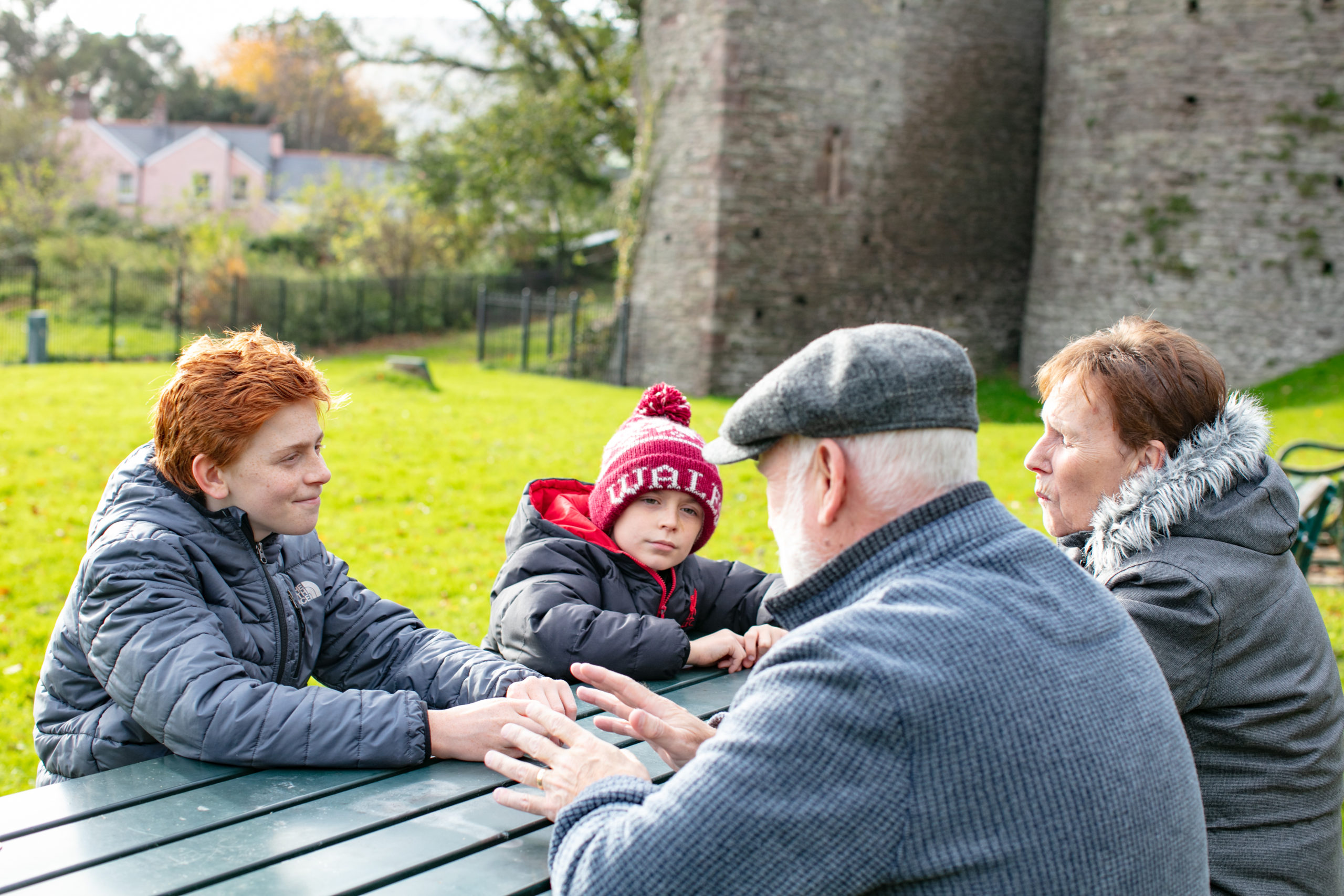 family sitting around a bench
